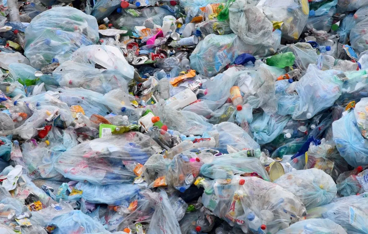 A heap of plastic waste: bottles, caps and bags